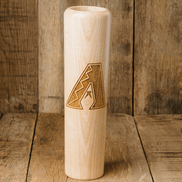Wooden cylindrical object with a laser-engraved logo on a wooden background