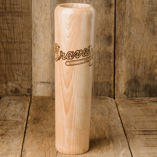 Wooden baseball bat with 'Braves' engraving on a wooden background