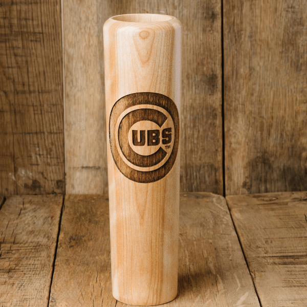 Wooden baseball bat with 'Cubs' engraving on a wooden background
