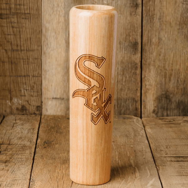 Wooden baseball bat with 'White Sox' logo on a wooden background