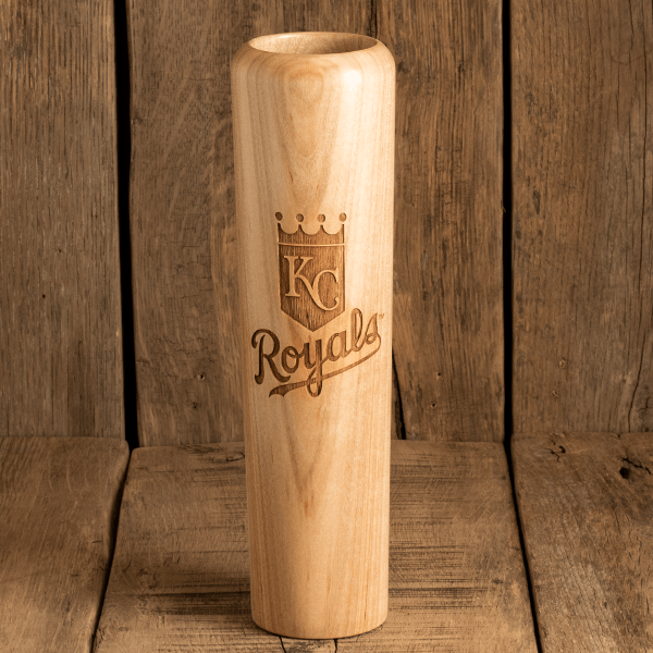 Wooden baseball bat with 'KC Royals' engraving on a wooden background