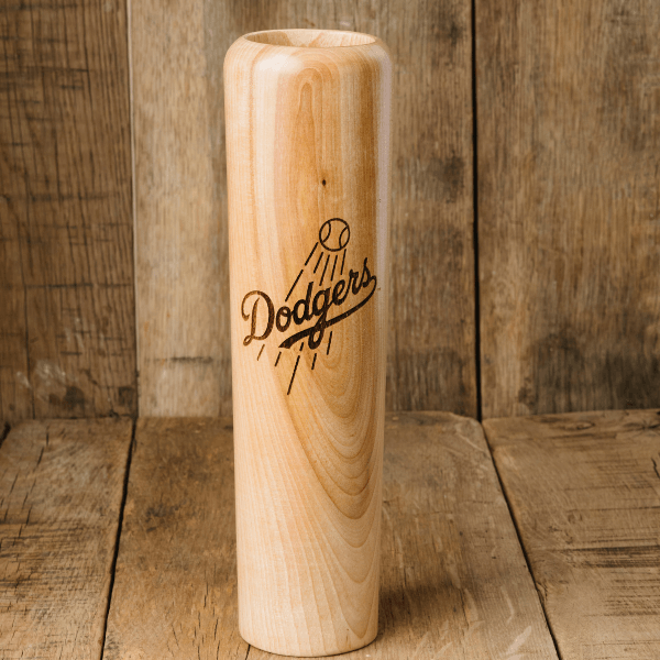 Wooden baseball bat with 'Dodgers' engraving on a wooden background