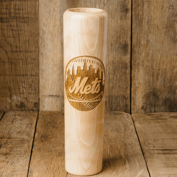 Wooden baseball bat with 'Mets' engraving on a wooden background