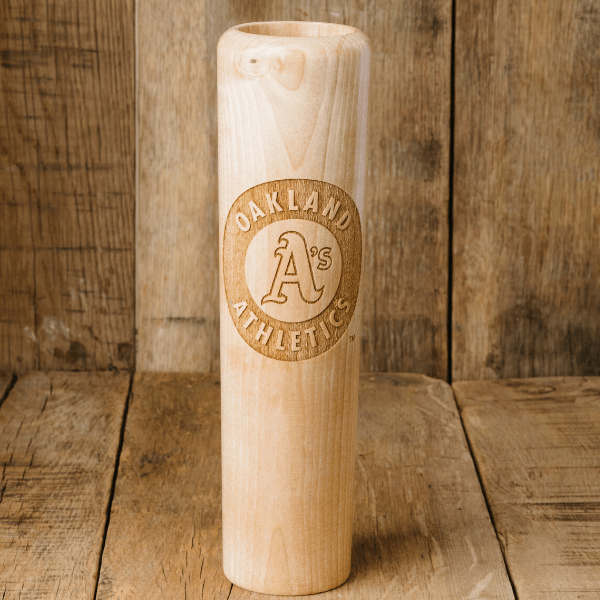 Wooden baseball bat with Oakland Athletics logo on a wooden background