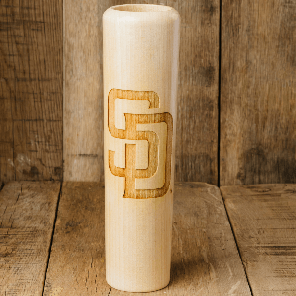 Wooden vase with a engraved logo on a wooden surface