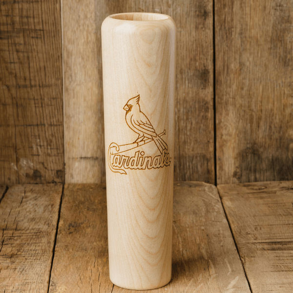 Wooden baseball bat with 'Cardinals' engraving on a wooden background