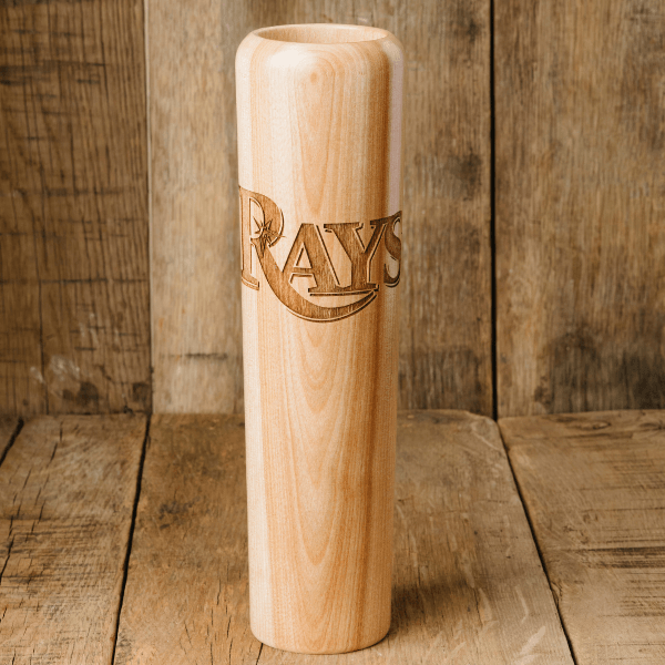 Wooden bat with 'Rays' engraving on a wooden background