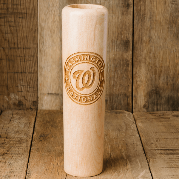 Wooden bat with 'Washington Nationals' logo on a wooden background
