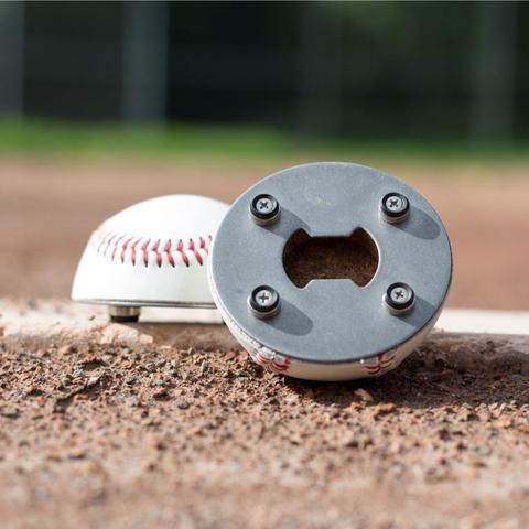 Baseball with a metal cap featuring bottle opener holes on a baseball field.