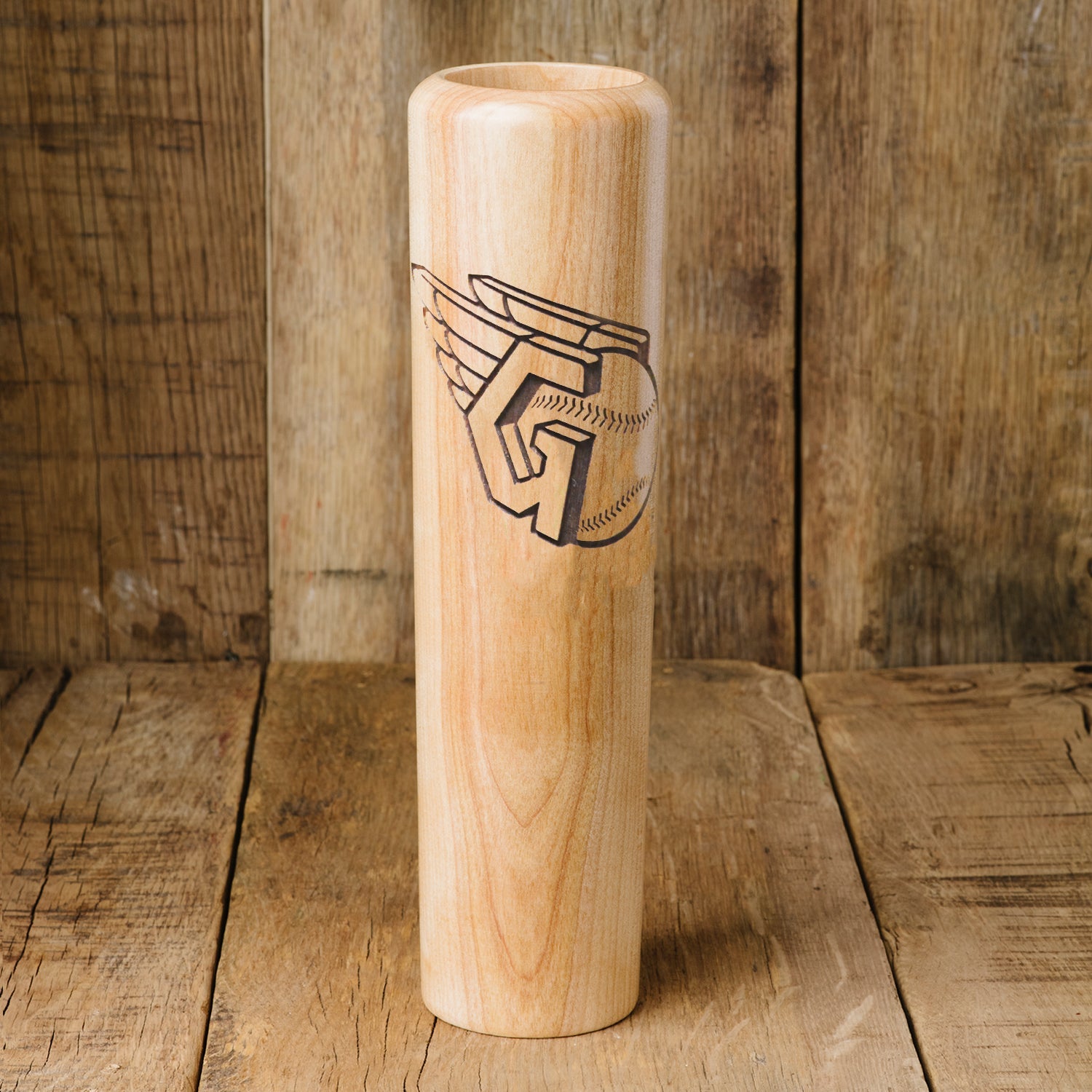 Wooden baseball bat with engraved logo on a wooden background