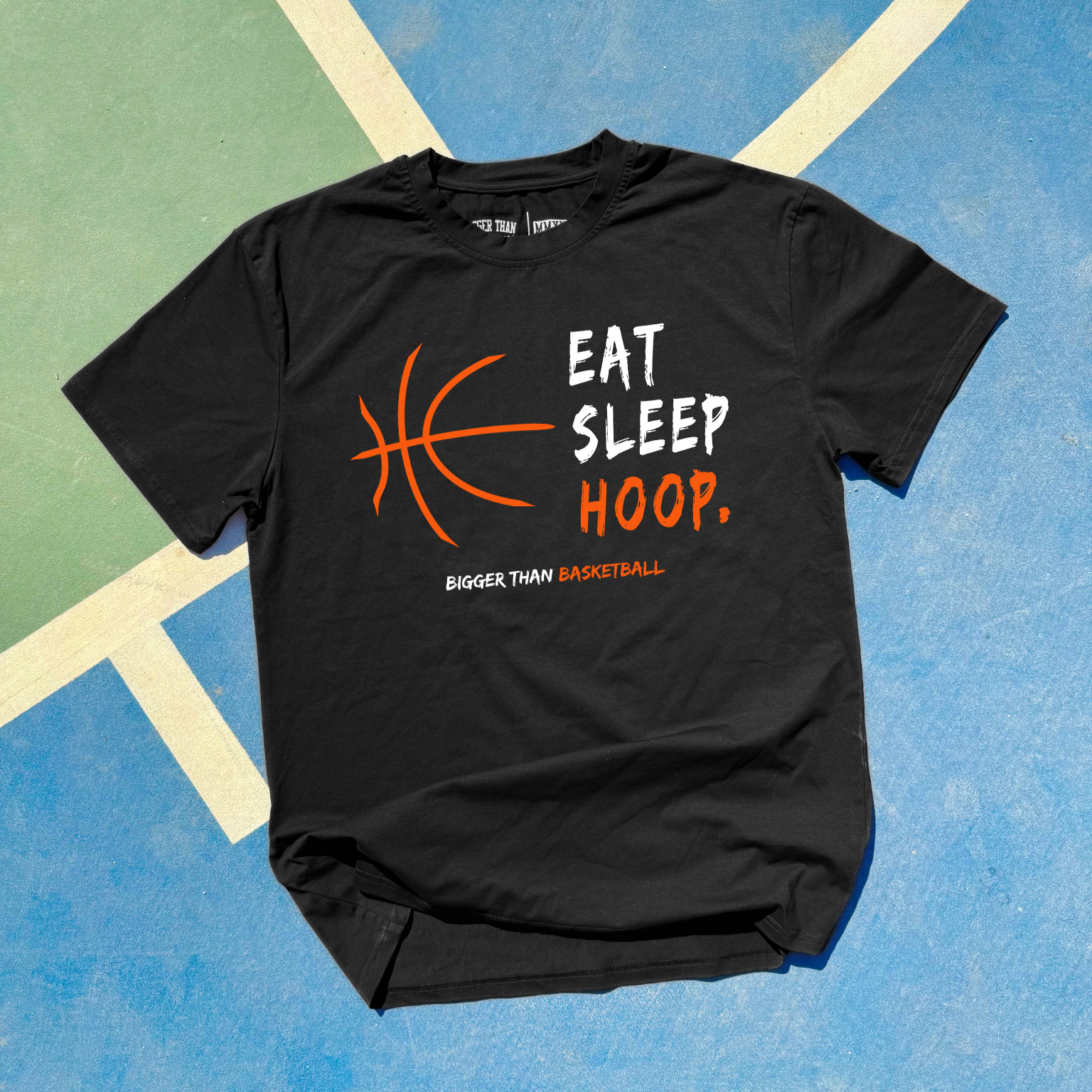 Black t-shirt with 'Eat Sleep Hoop' design on a colorful background