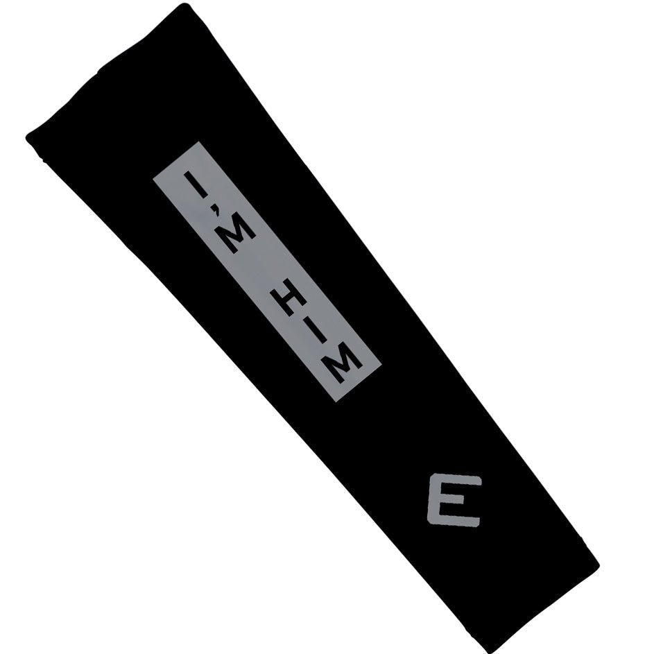 Black rectangular object with 'I'M HIM' text on a white background