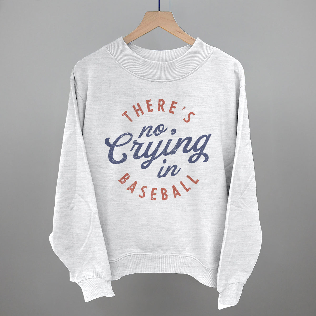 Collection of Gray sweatshirt with 'There's no crying in baseball' text on a gray background in a gallery layout