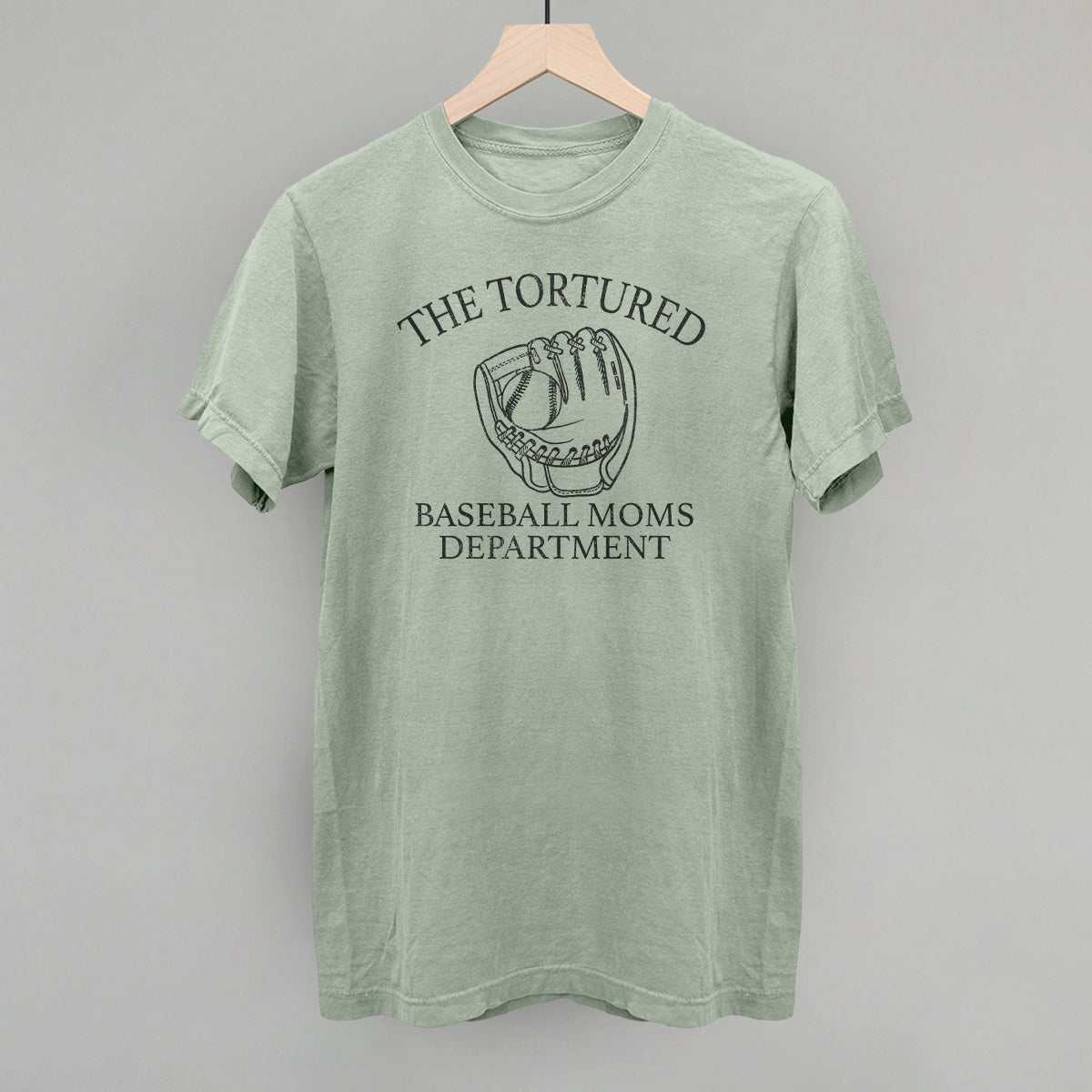 Collection of Green t-shirt with 'The Tortured Baseball Moms Department' graphic on a hanger against a gray background in a gallery layout