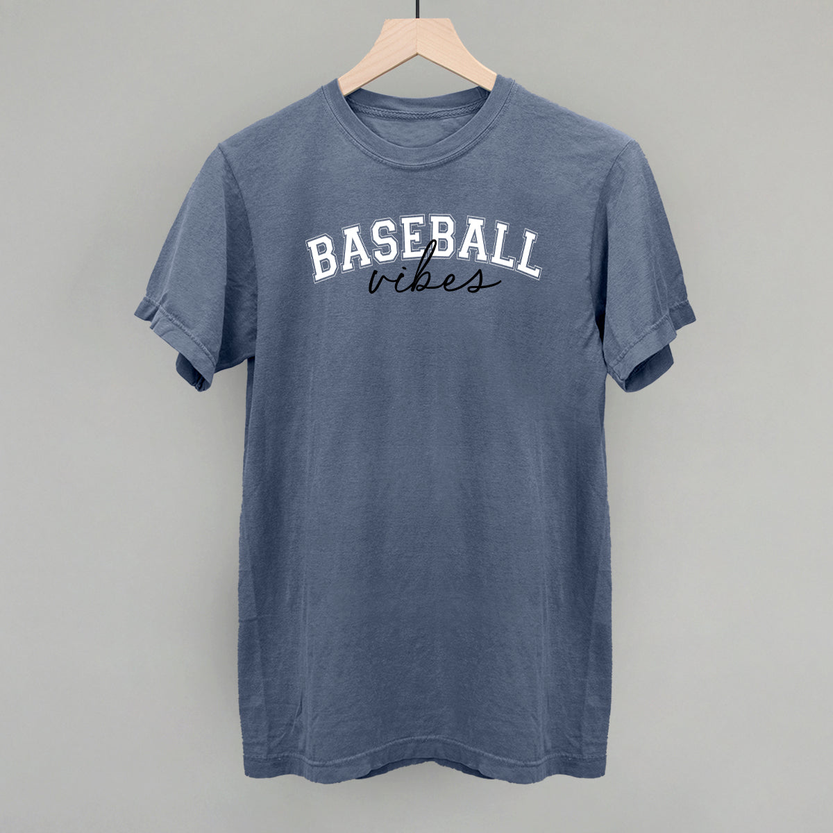 Blue t-shirt with 'BASEBALL vibes' text on a gray background