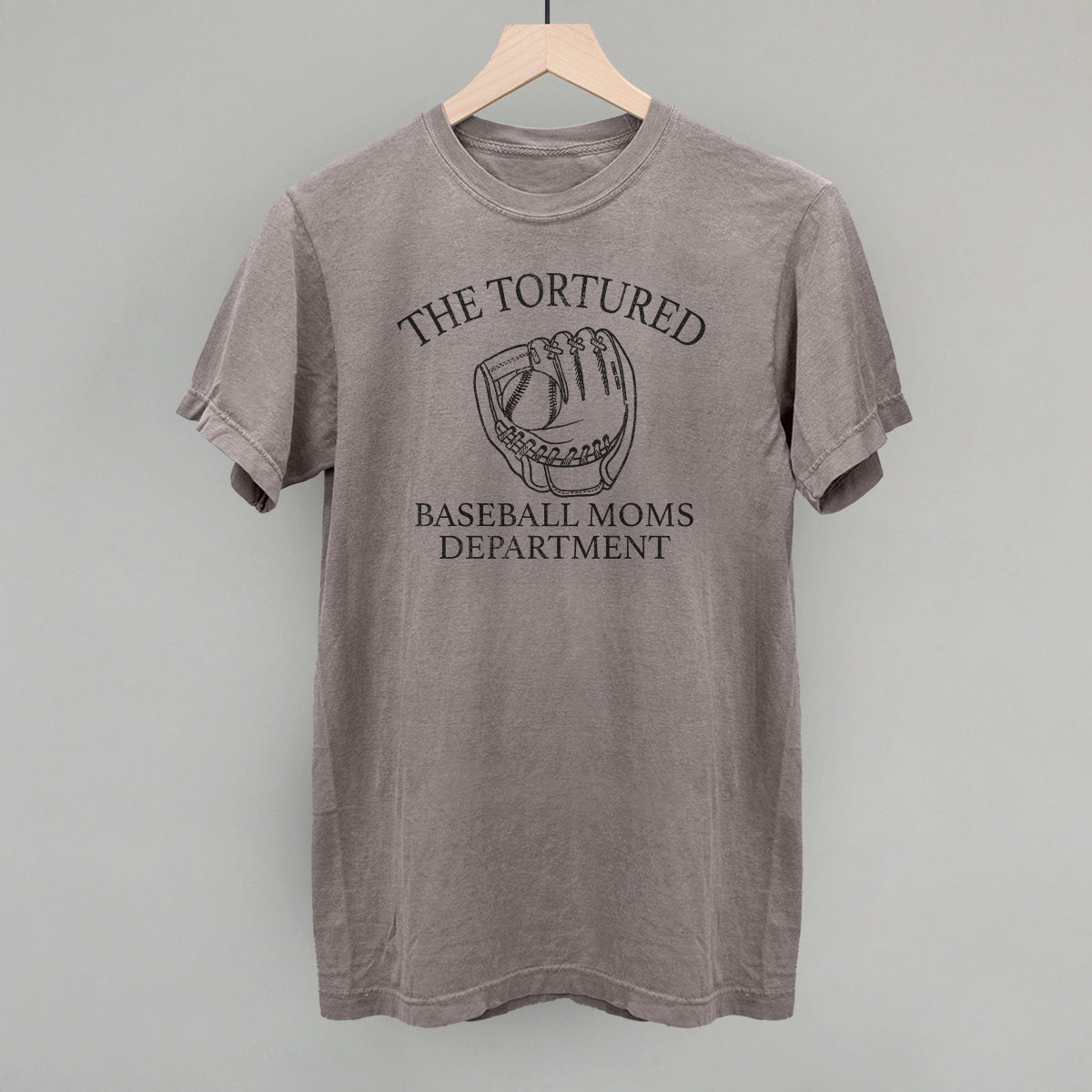 Collection of Gray t-shirt with 'The Tortured Baseball Moms Department' text and graphic on a hanger against a gray background in a gallery layout