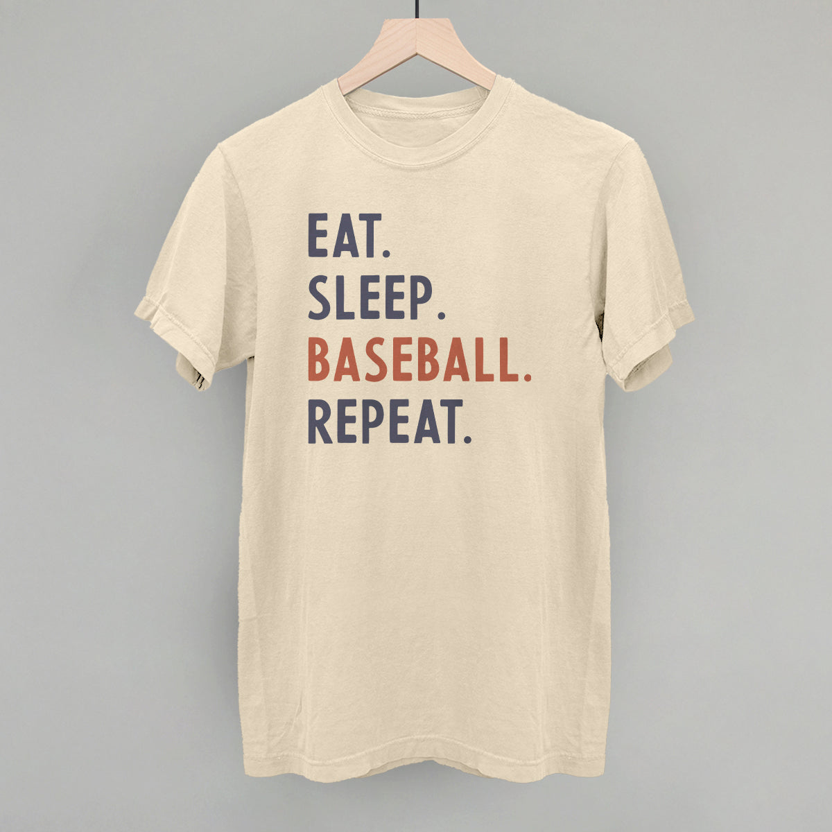 Beige t-shirt with 'Eat. Sleep. Baseball. Repeat.' text on a gray background