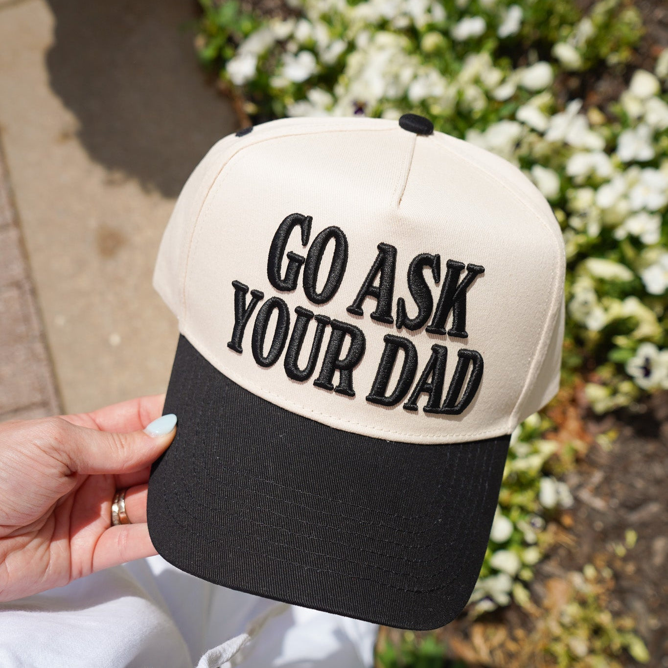 Collection of Cap with 'Go Ask Your Dad' text held by a person outdoors. in a gallery layout