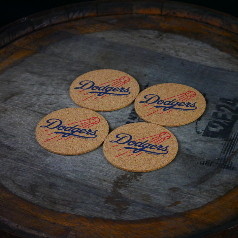Collection of Four cork coasters with 'Dodgers' logo on a rustic wooden surface in a gallery layout