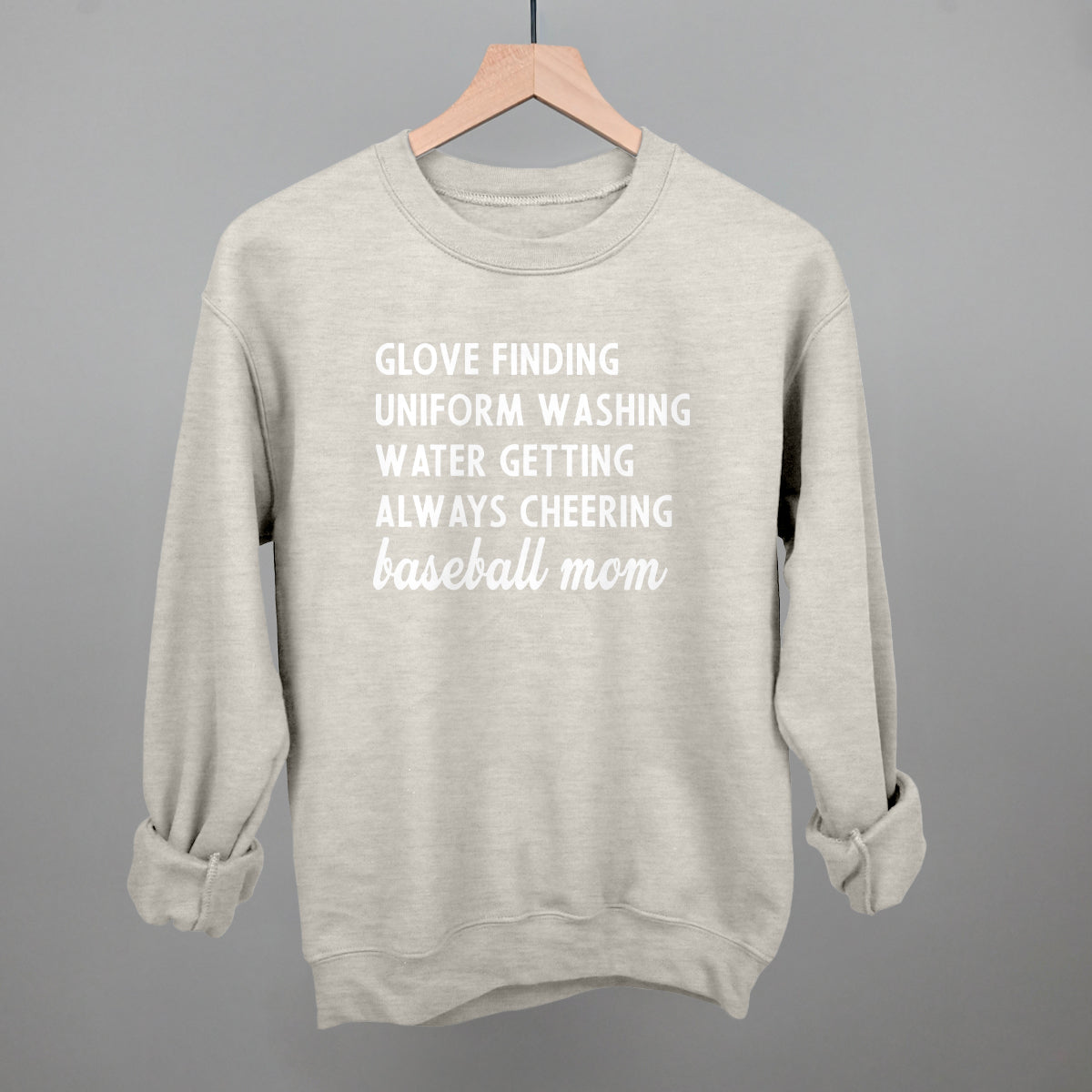 Gray comfort color sweatshirt with white text on a hanger against a gray background