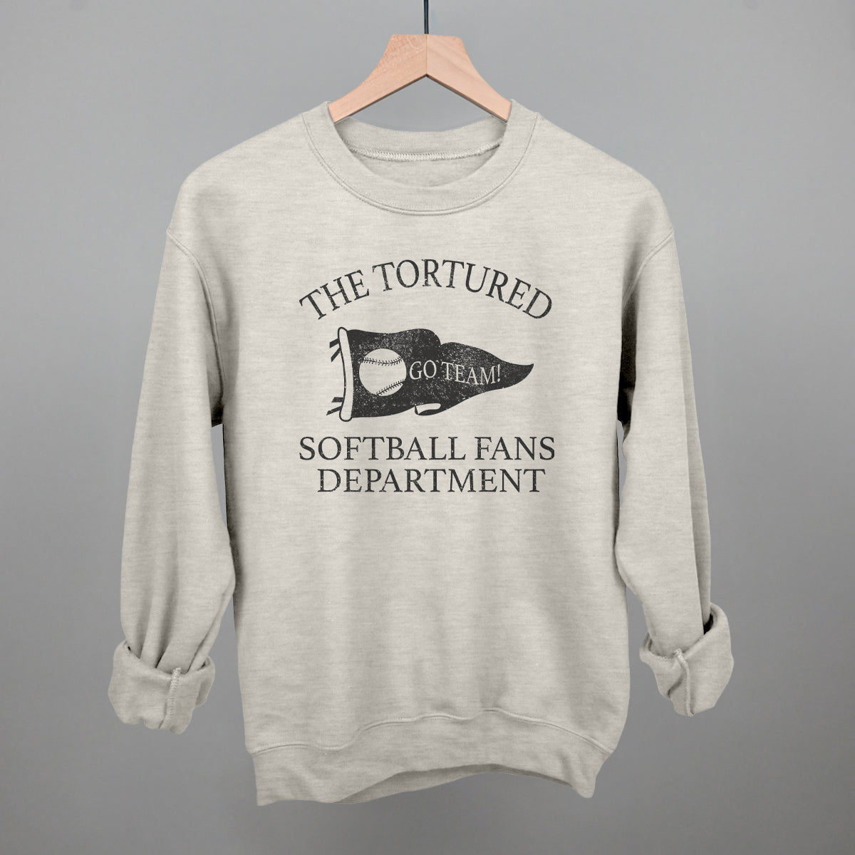 Collection of oatlmeal sweatshirt with printed text that says the tortured Softball fans department  in a gallery layout