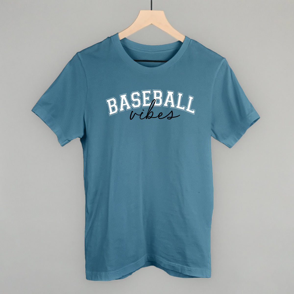 Collection of Blue t-shirt with 'BASEBALL vibes' text on a hanger against a gray background in a gallery layout