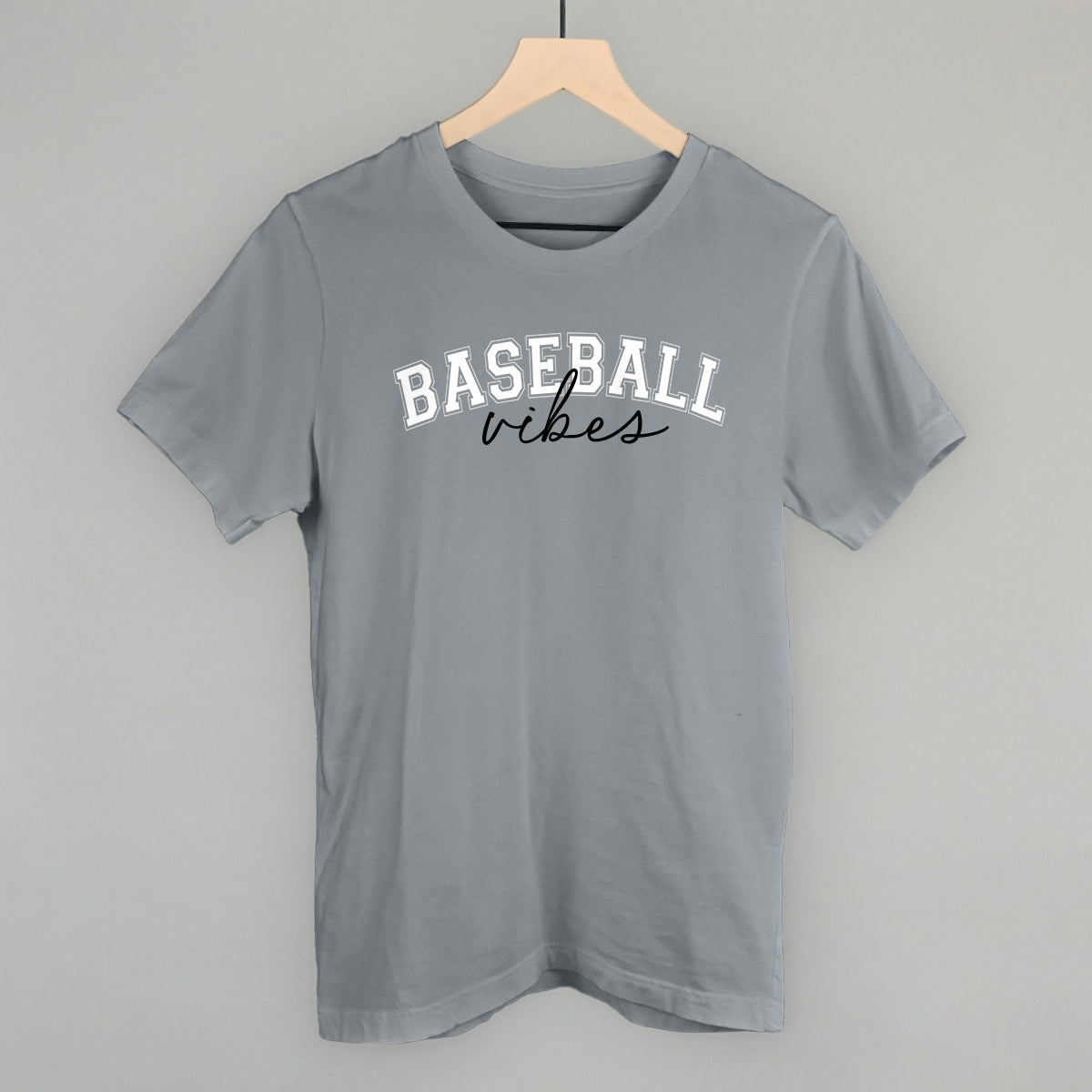 Gray t-shirt with 'BASEBALL vibes' text on a hanger against a gray background
