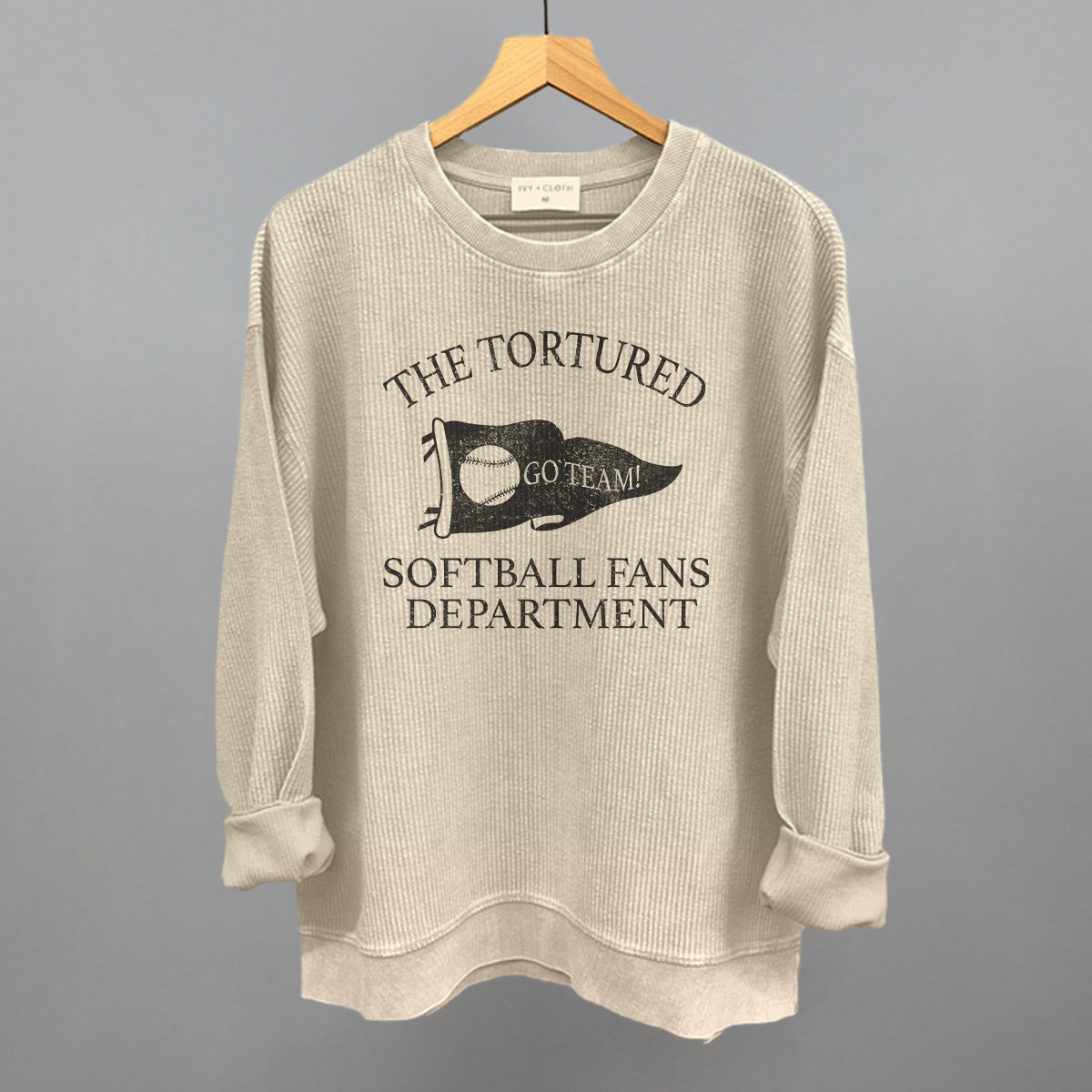Collection of Beige sweatshirt with graphic design that says the tortured Softball fans department  in a gallery layout