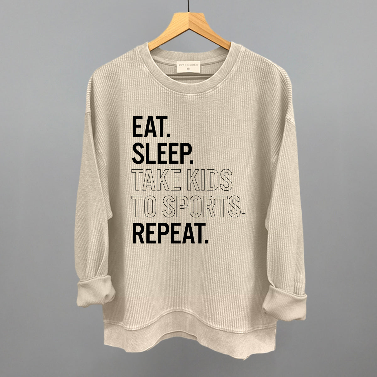 moonbeam comfort colors corded crew sweatshirt with text on a hanger against a gray background