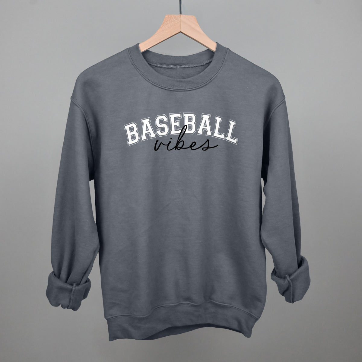 charcoal sweatshirt with 'BASEBALL vibes' text on a hanger against a gray background