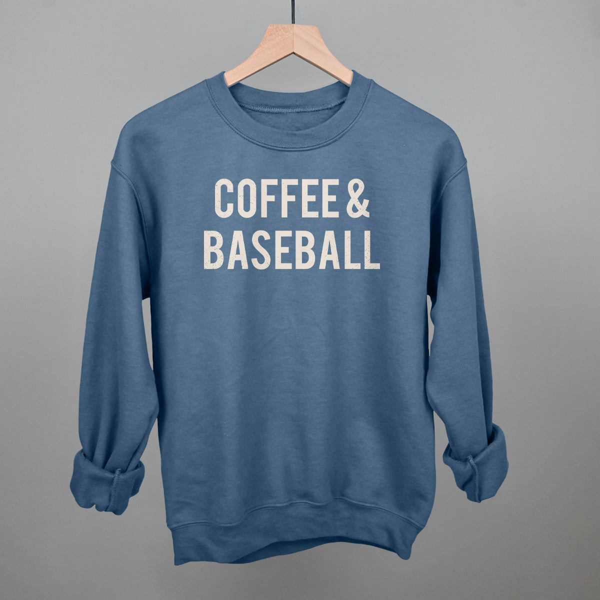 Blue comfort colors sweatshirt with 'COFFEE & BASEBALL' text on a gray background