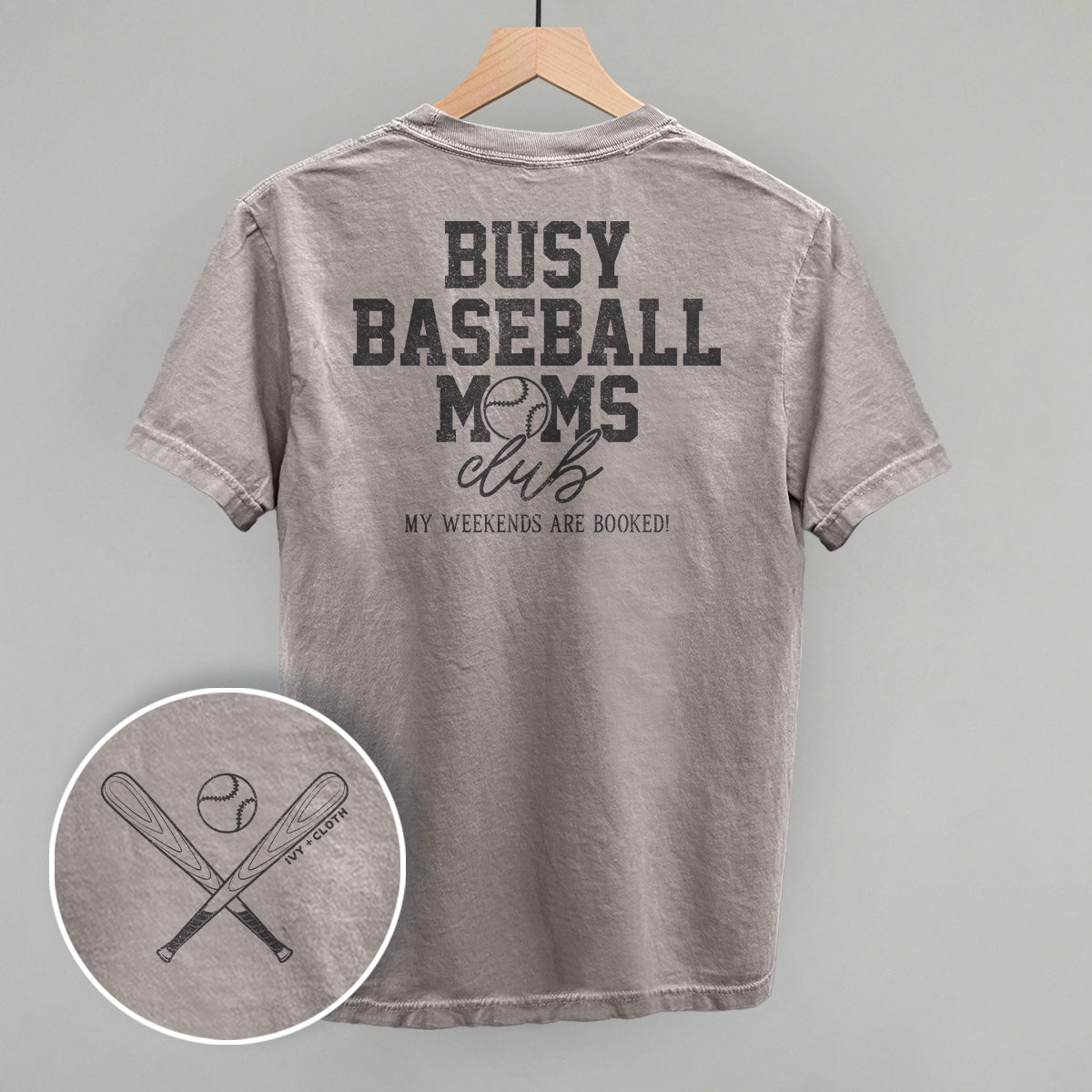 Collection of Gray t-shirt with 'Busy Baseball Moms Club' text on a hanger against a gray background in a gallery layout