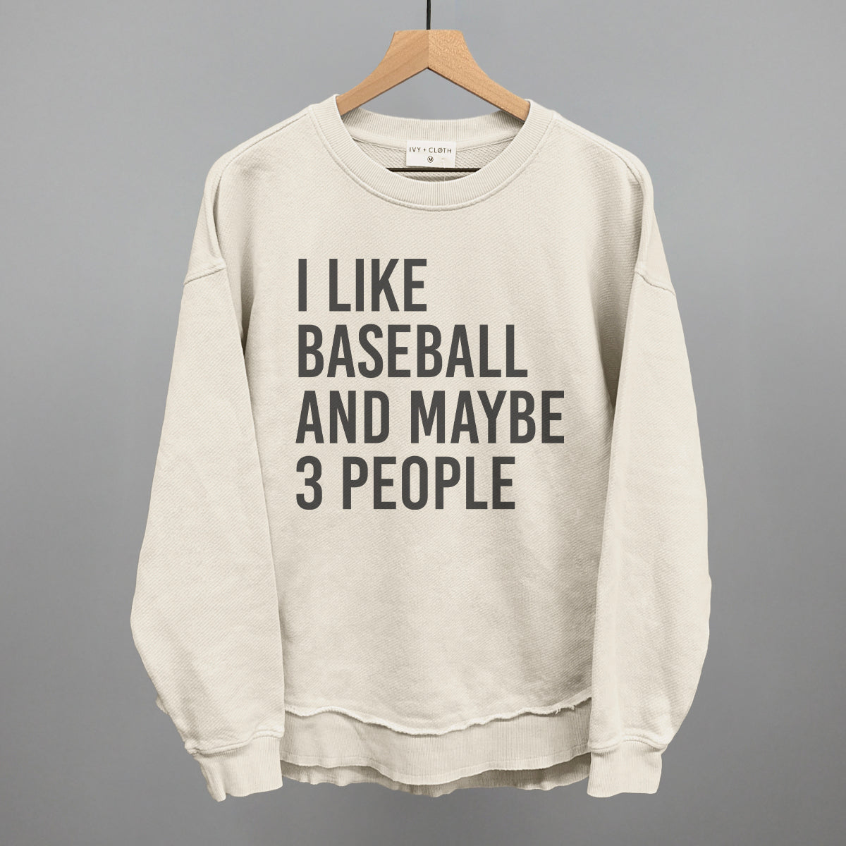 Collection of Tapioca sweatshirt with text 'I like baseball and maybe 3 people' on a hanger against a gray background in a gallery layout