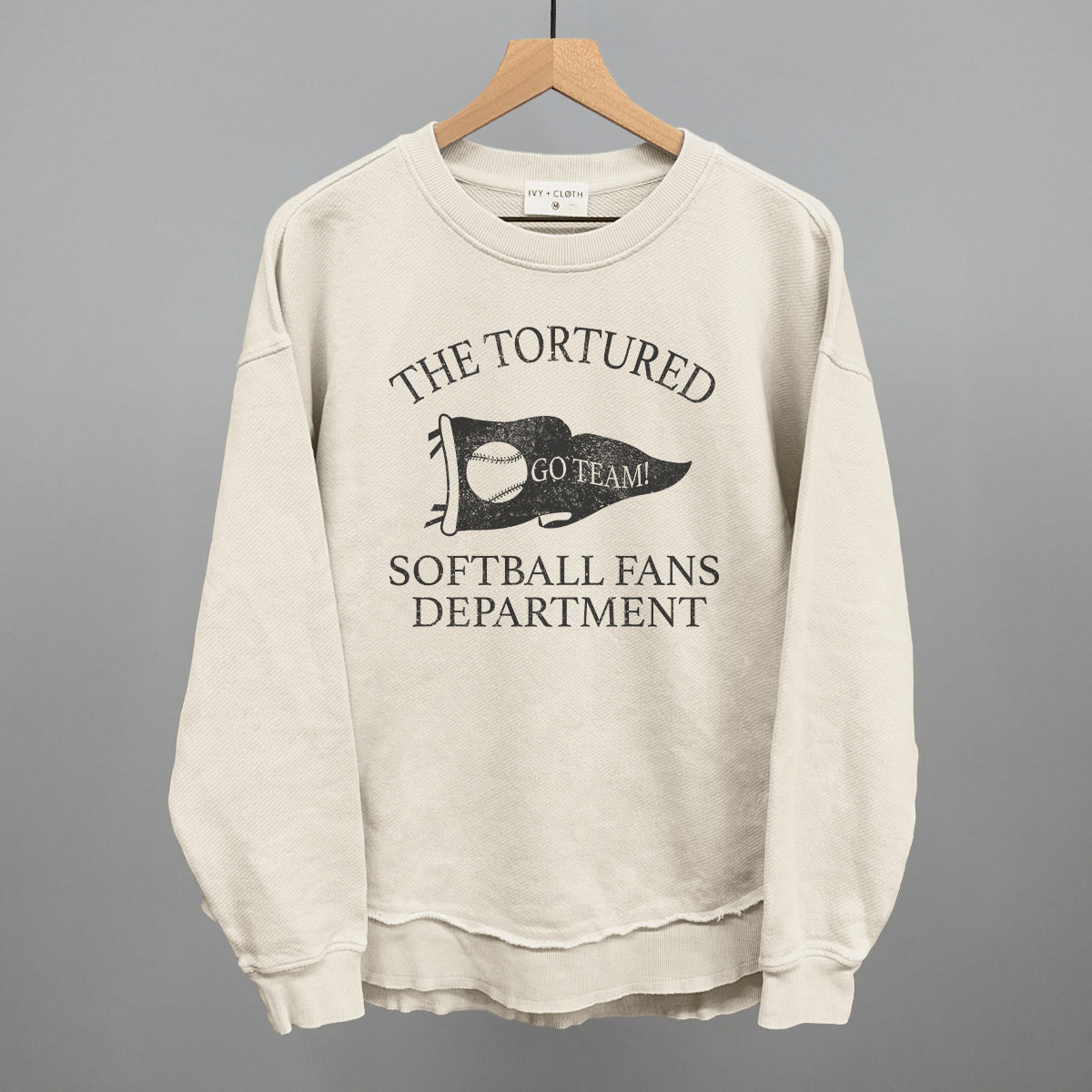 Collection of Beige sweatshirt with text that says the tortured Softball fans department in a gallery layout