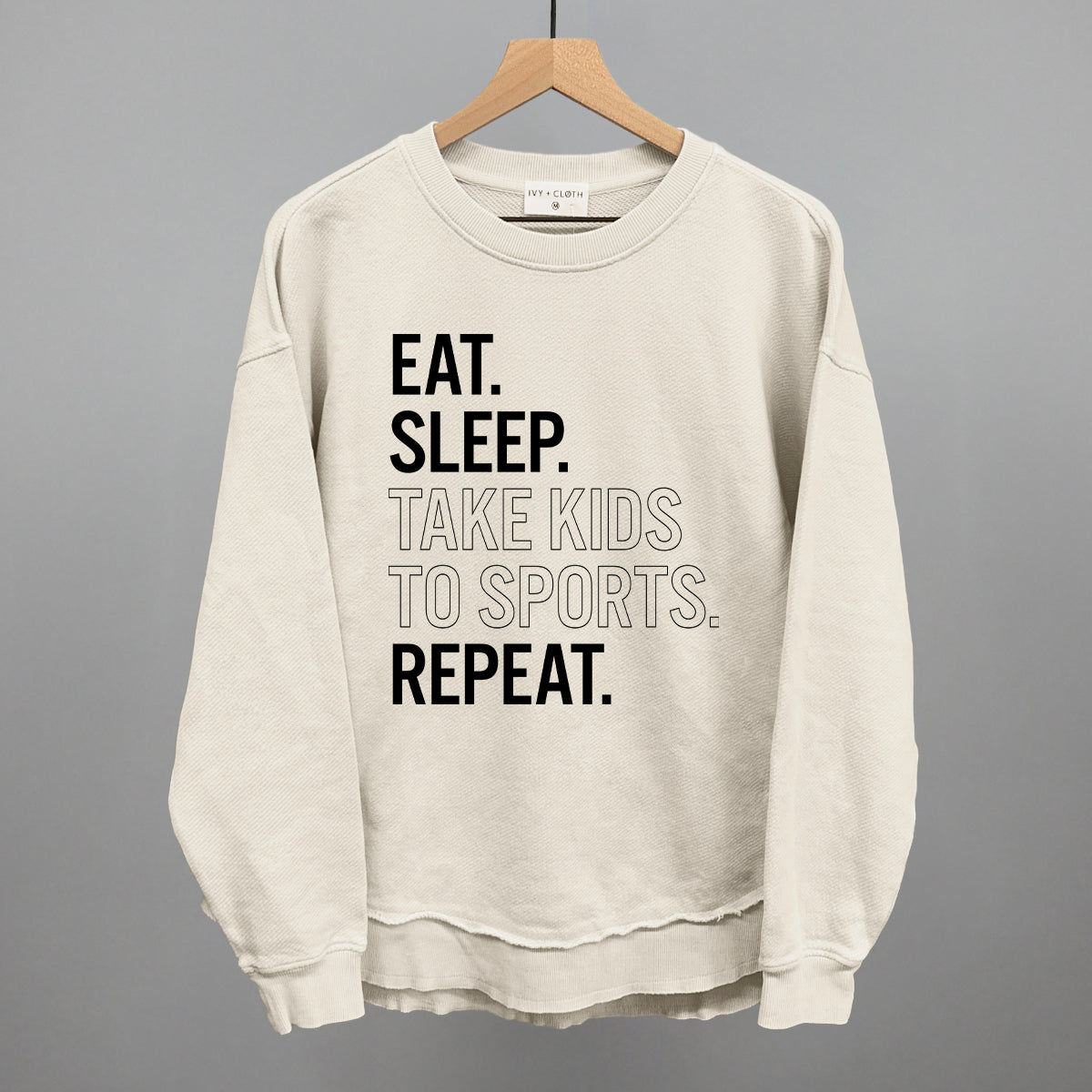 tapioca comfort colors sweatshirt with text on a hanger against a gray background