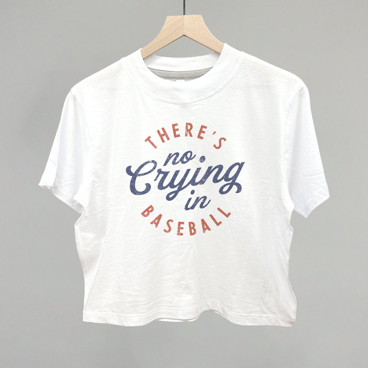 Collection of White t-shirt with 'There's no crying in baseball' text on a gray background in a gallery layout