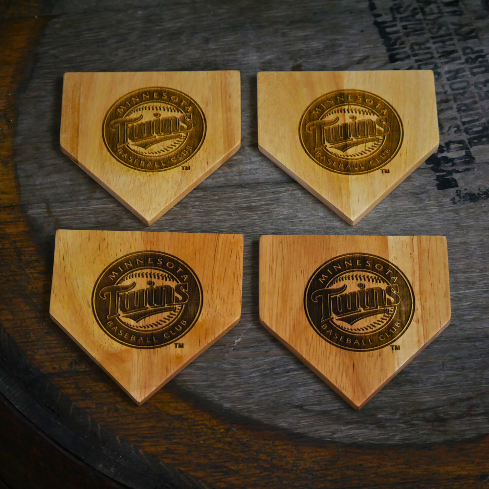 Collection of Four wooden coasters with engraved logos on a dark surface in a gallery layout