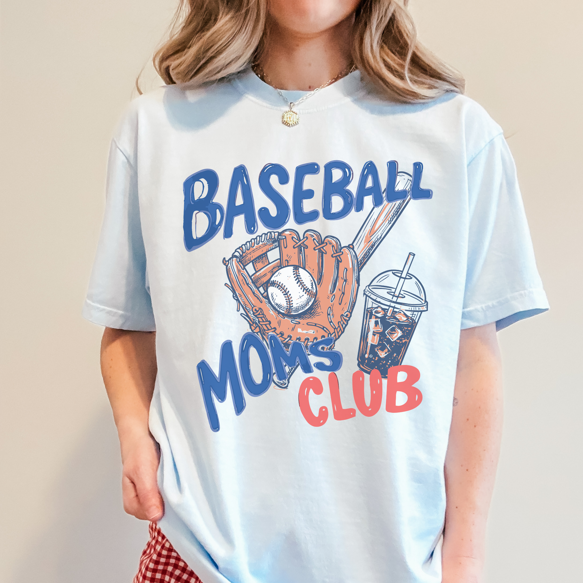 Person wearing a t-shirt with 'Baseball Moms Club' design on a plain background