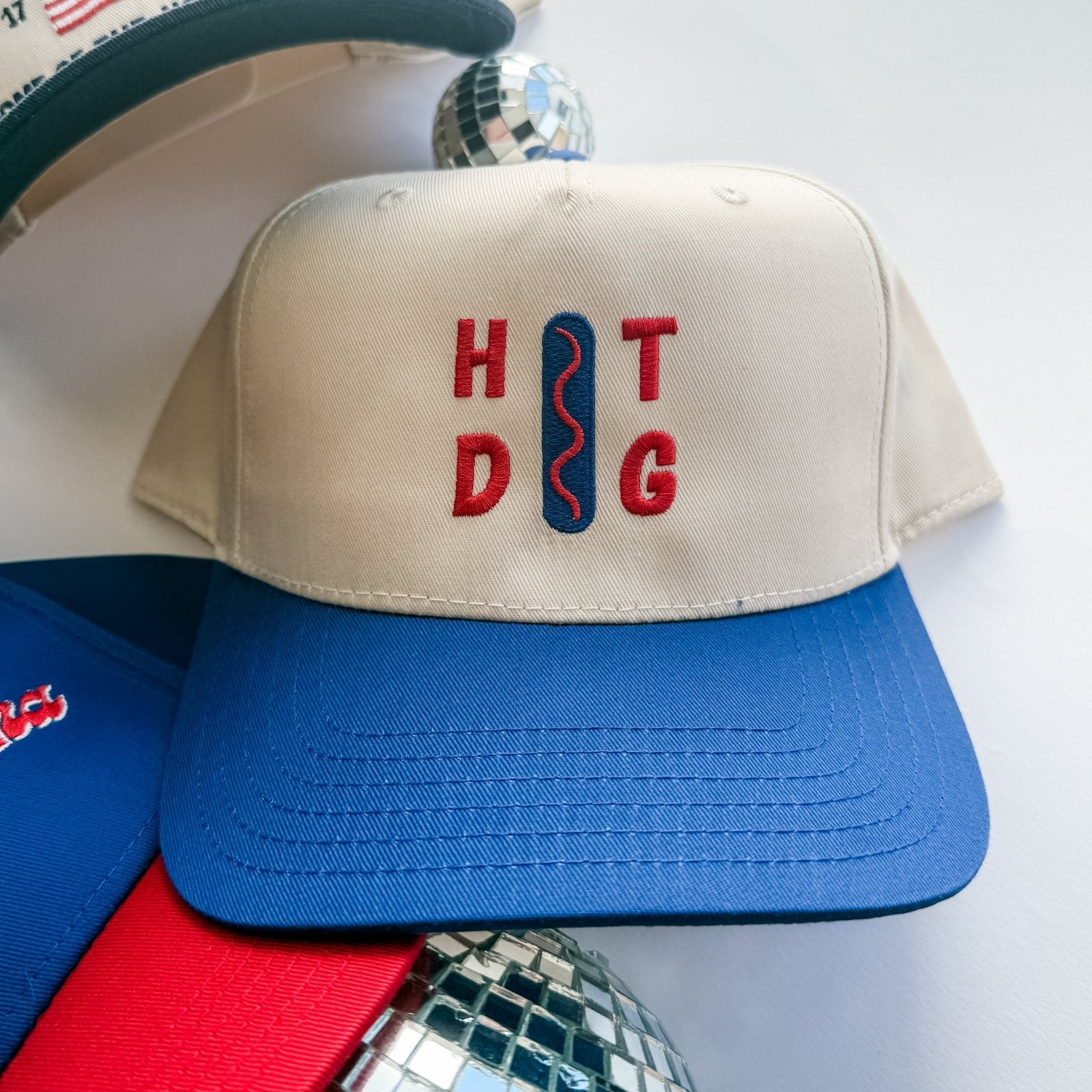 Collection of Beige cap with 'HOT DoG' text on a white background in a gallery layout