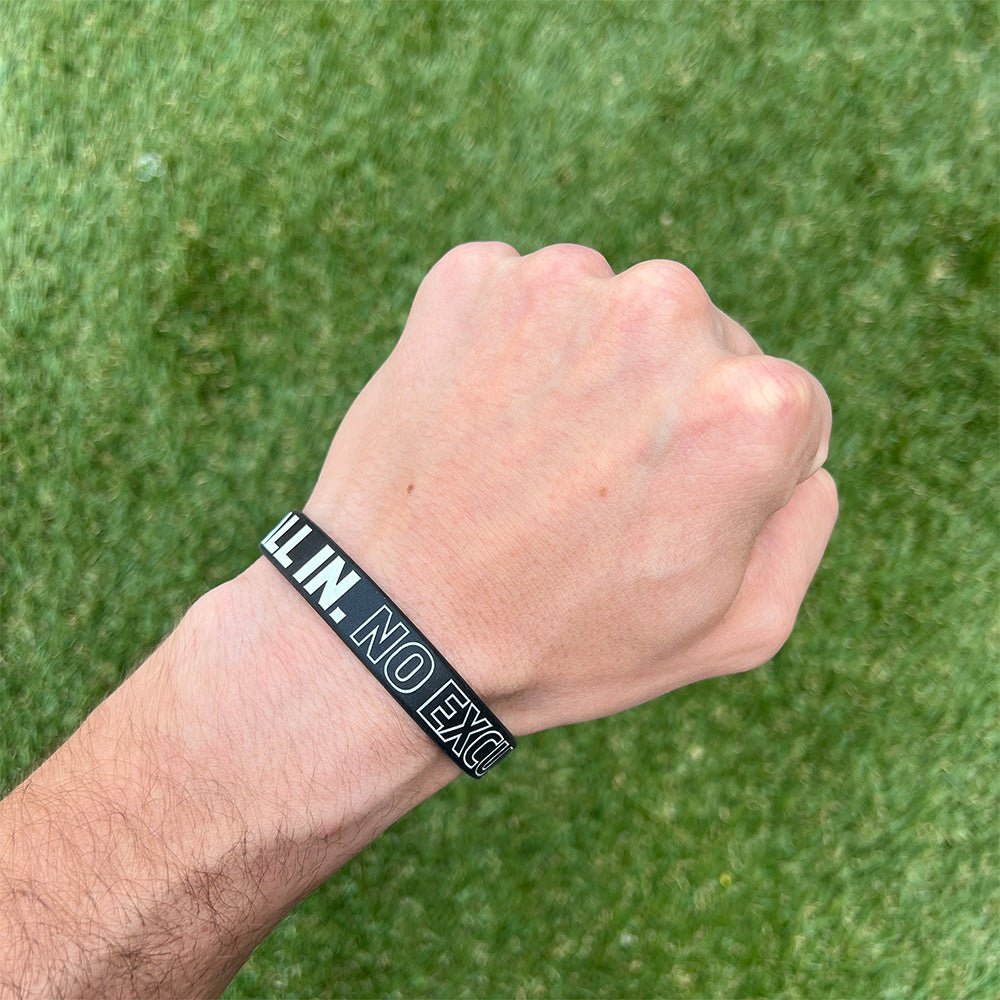 Collection of Hand wearing a black wristband with white text against a green grass background in a gallery layout
