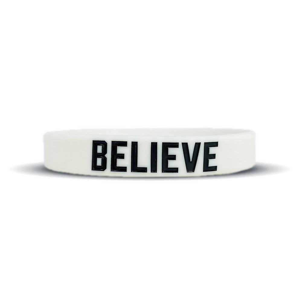 Collection of White wristband with 'BELIEVE' printed on it against a white background in a gallery layout